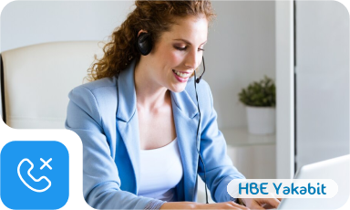 A call centre agent working at a desk with a headset